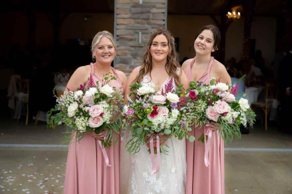 2024 Beconside, Kensa and her bridesmaids all with home grown flowers in shades of pink and white.