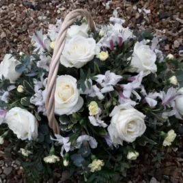 Beautiful gift basket with white Roses, white Alstroemeria, spray Carnations and complimentary foliage.