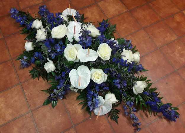 Double ended coffin spray with White Roses, Blue Delphiniums, White Anthuriums and complimentary foliage's