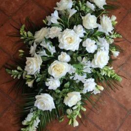 White and green pallet for this double ended coffin spray complete with complimentary foliage