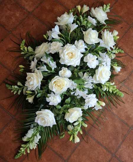 White and green pallet for this double ended coffin spray complete with complimentary foliage