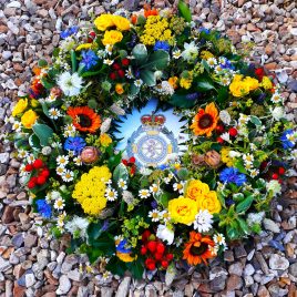 This is a beautiful wreath in summer shades a countryfied look with many different types of flowers like mini Sunflowers, Nigella, Cornflowers, red Hypericum, yellow Spray Roses, Tanacetum, Alchemilla mollis Sedum and mixed foliage's